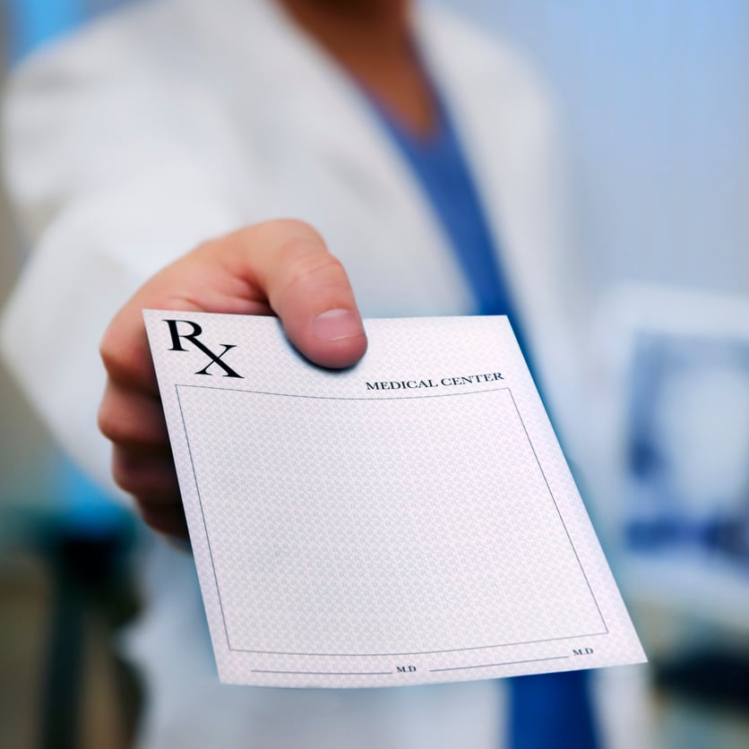 Doctor's Hand holding Prescription Pad